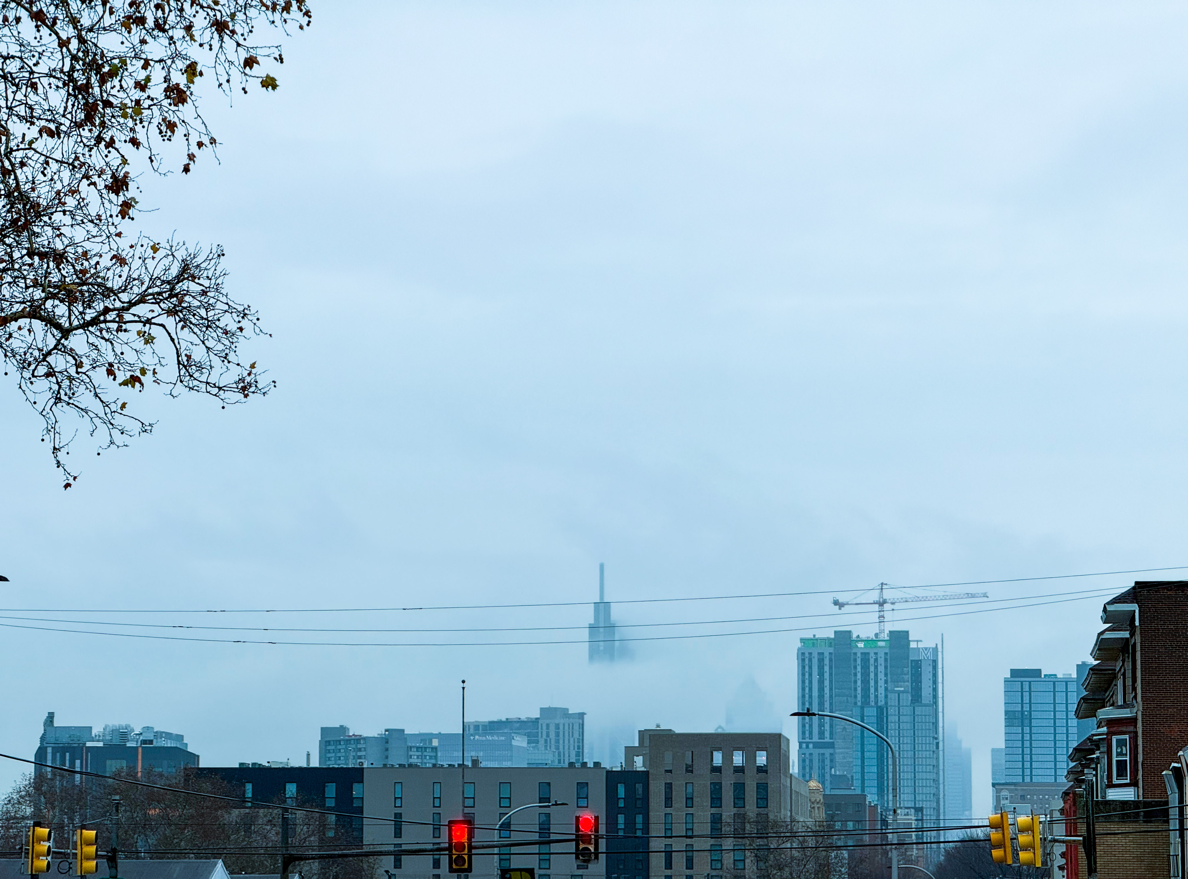 Philadelphia buildings with the skyline engulfed in clouds and fog on a cold winter day.